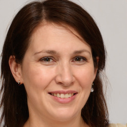 Joyful white adult female with medium  brown hair and brown eyes