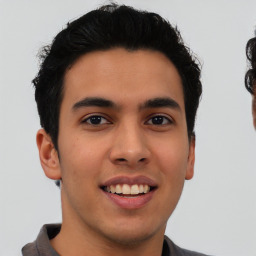 Joyful latino young-adult male with short  brown hair and brown eyes