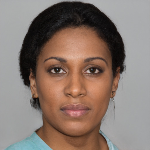 Joyful black young-adult female with short  brown hair and brown eyes