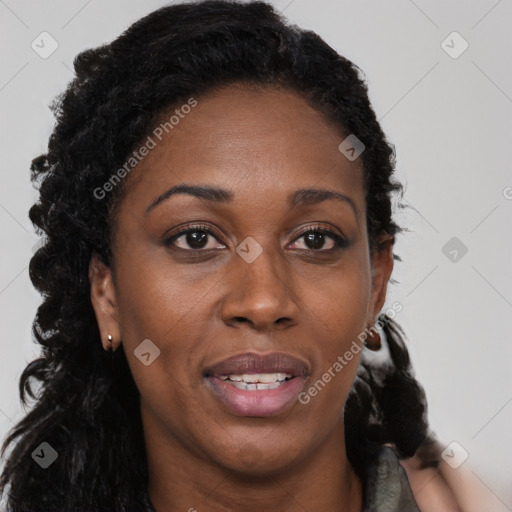 Joyful black young-adult female with long  brown hair and brown eyes