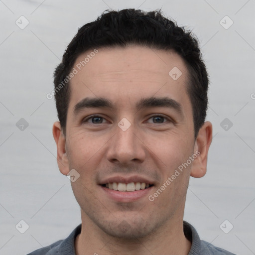 Joyful white young-adult male with short  black hair and brown eyes