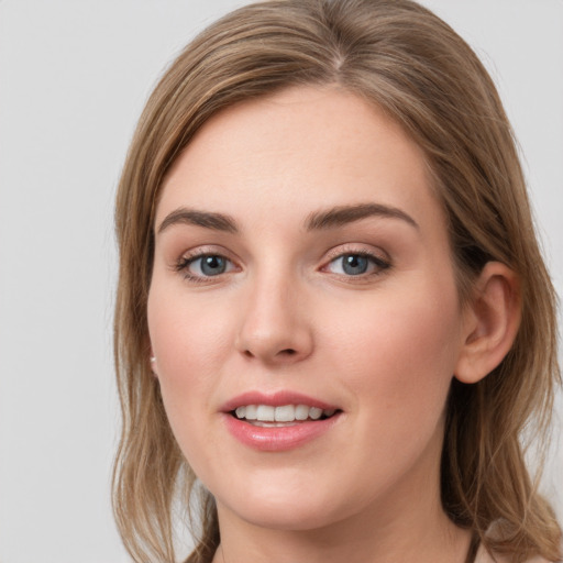 Joyful white young-adult female with long  brown hair and grey eyes