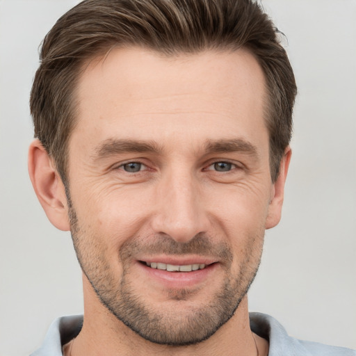 Joyful white adult male with short  brown hair and grey eyes