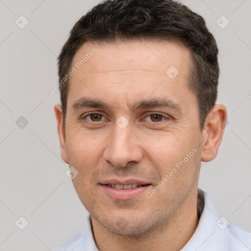 Joyful white adult male with short  brown hair and brown eyes