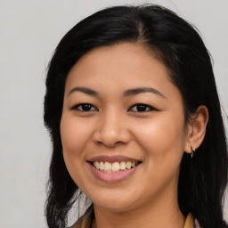 Joyful latino young-adult female with long  brown hair and brown eyes