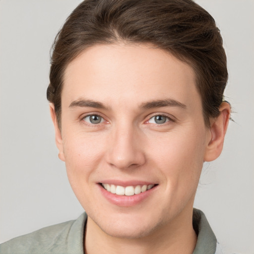 Joyful white young-adult female with short  brown hair and grey eyes