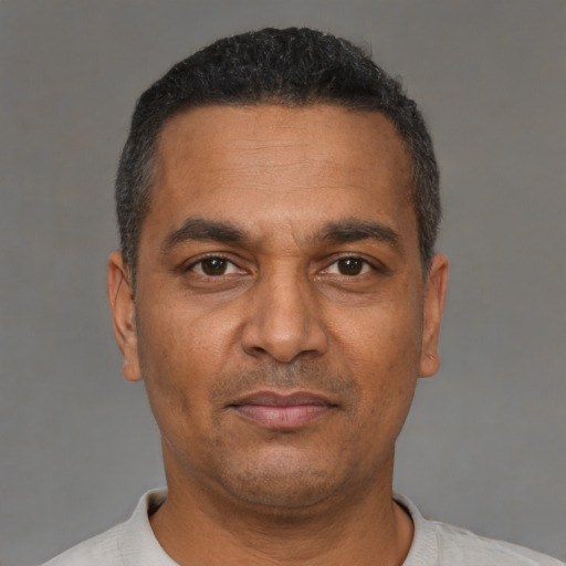 Neutral black adult male with short  black hair and brown eyes