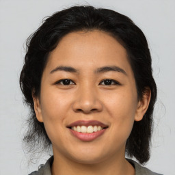 Joyful asian young-adult female with medium  black hair and brown eyes