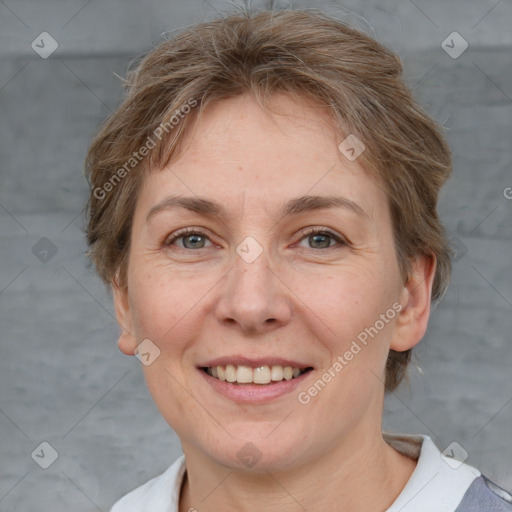 Joyful white adult female with short  brown hair and grey eyes