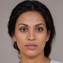 Joyful latino young-adult female with long  brown hair and brown eyes