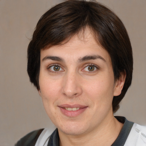 Joyful white adult female with medium  brown hair and brown eyes