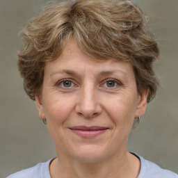 Joyful white adult female with short  brown hair and brown eyes