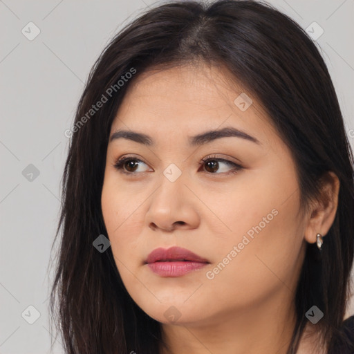 Joyful asian young-adult female with long  brown hair and brown eyes