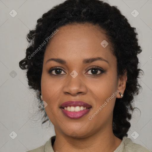 Joyful black young-adult female with long  black hair and brown eyes