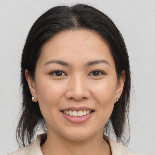 Joyful asian young-adult female with medium  brown hair and brown eyes