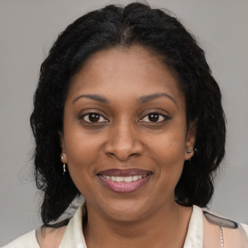 Joyful black young-adult female with medium  brown hair and brown eyes