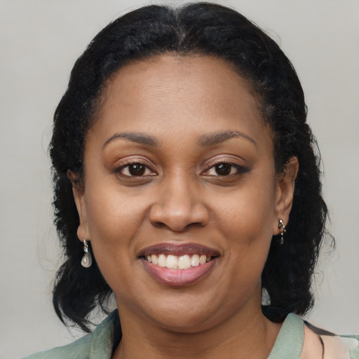 Joyful latino adult female with long  brown hair and brown eyes