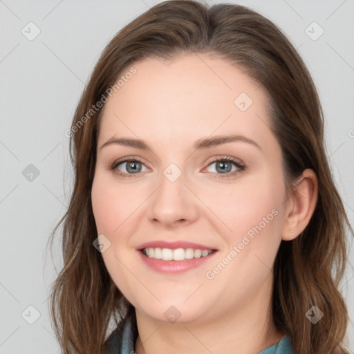 Joyful white young-adult female with long  brown hair and blue eyes