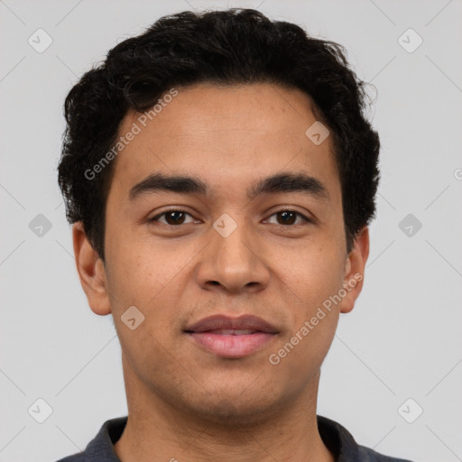 Joyful latino young-adult male with short  brown hair and brown eyes