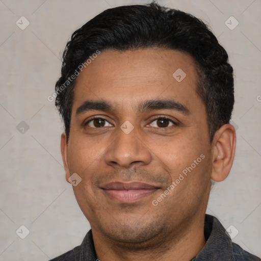 Joyful latino young-adult male with short  black hair and brown eyes