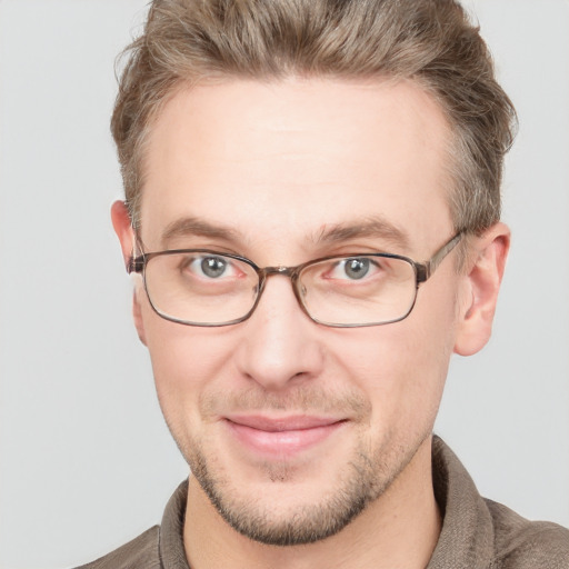 Joyful white adult male with short  brown hair and blue eyes