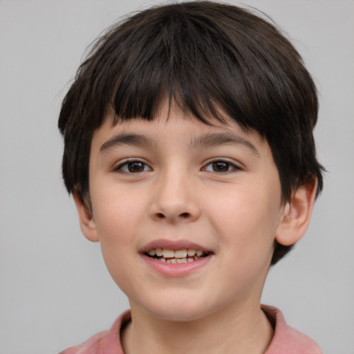 Joyful white child male with short  brown hair and brown eyes