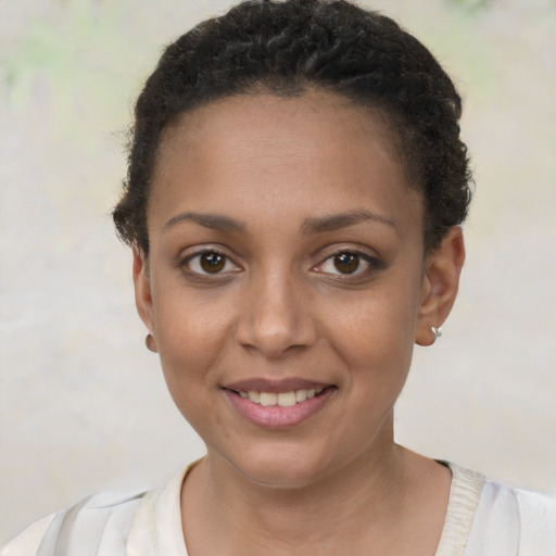 Joyful black young-adult female with short  brown hair and brown eyes