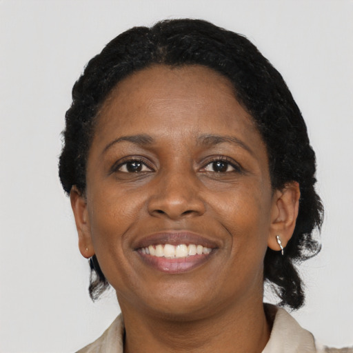 Joyful black adult female with medium  black hair and brown eyes
