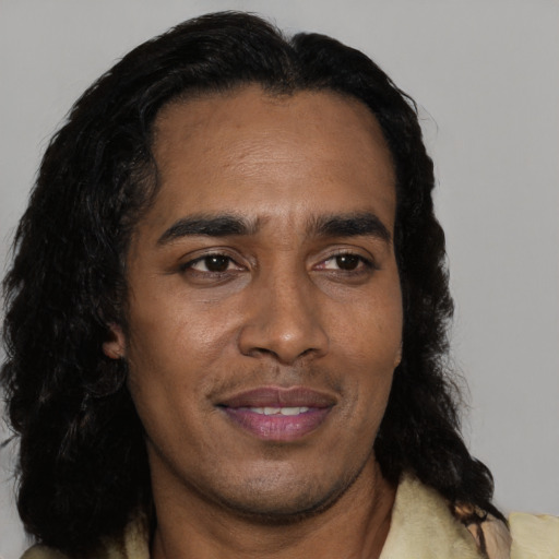 Joyful black adult male with short  black hair and brown eyes