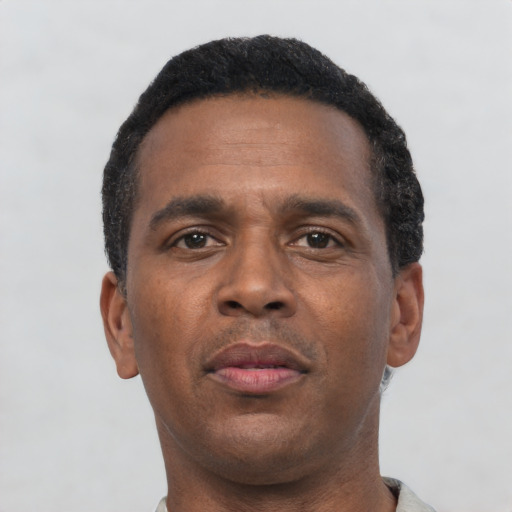 Neutral black adult male with short  black hair and brown eyes