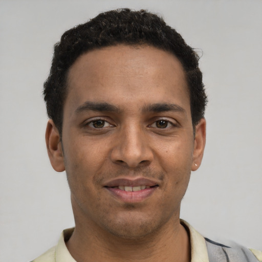 Joyful white young-adult male with short  black hair and brown eyes