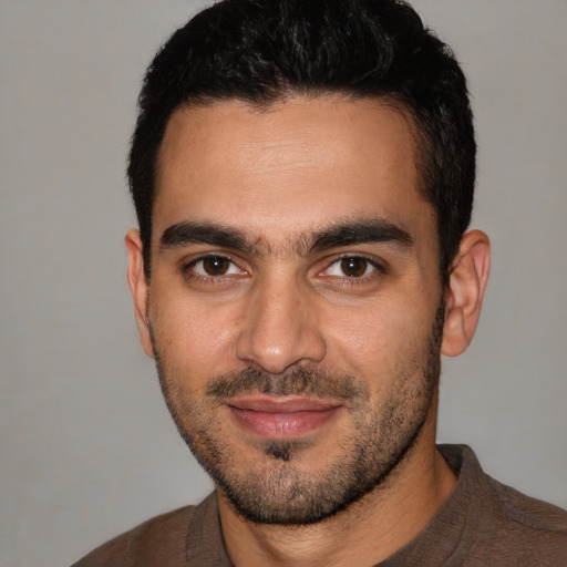 Joyful white young-adult male with short  black hair and brown eyes