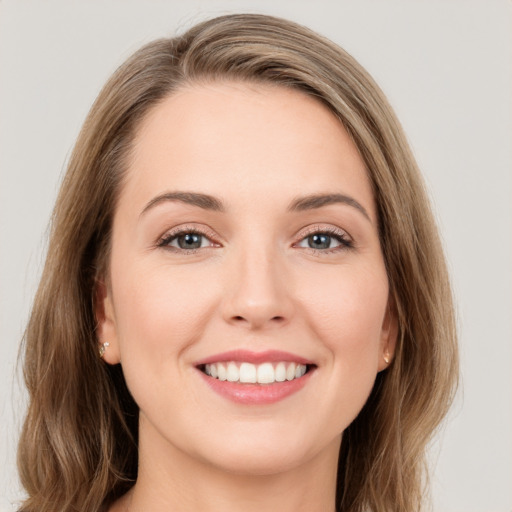 Joyful white young-adult female with long  brown hair and grey eyes