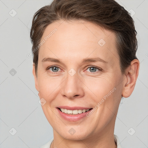 Joyful white adult female with short  brown hair and grey eyes