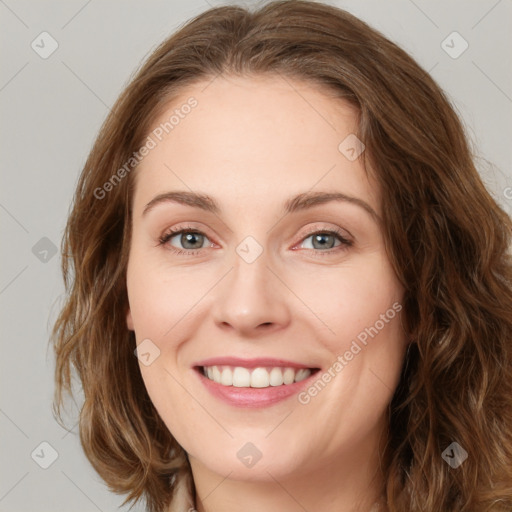 Joyful white young-adult female with long  brown hair and green eyes