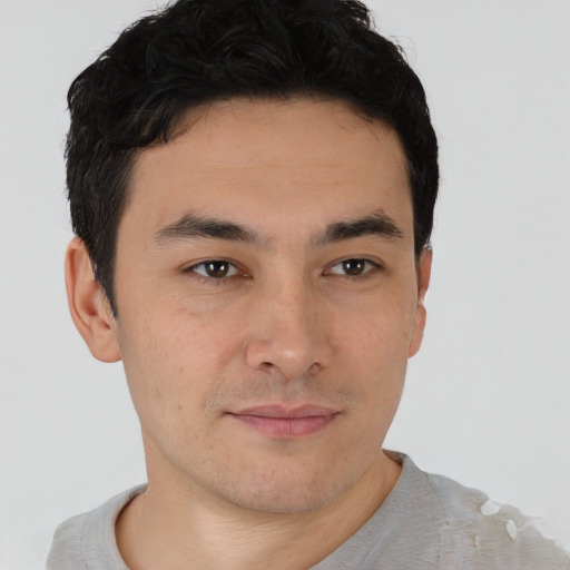 Joyful asian young-adult male with short  brown hair and brown eyes