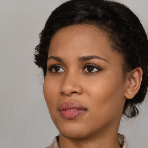 Joyful black young-adult female with medium  brown hair and brown eyes