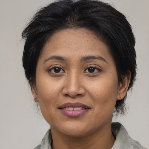 Joyful asian young-adult female with medium  brown hair and brown eyes