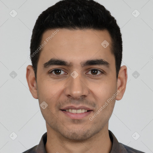 Joyful white young-adult male with short  black hair and brown eyes