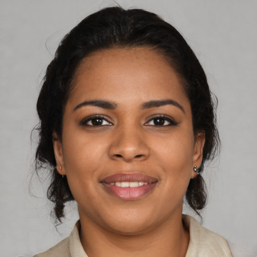 Joyful black young-adult female with medium  black hair and brown eyes