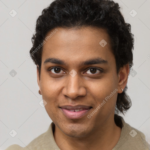 Joyful black young-adult male with short  brown hair and brown eyes