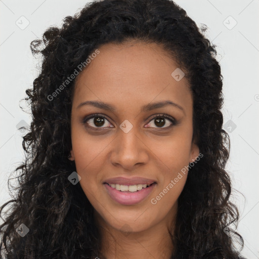 Joyful black young-adult female with long  brown hair and brown eyes