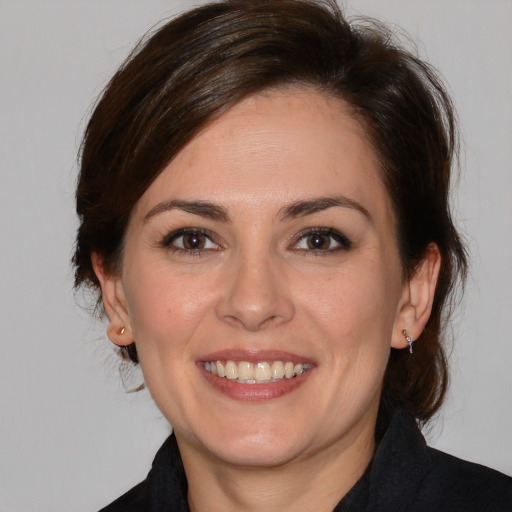 Joyful white adult female with medium  brown hair and brown eyes