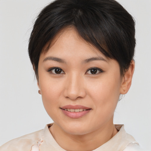 Joyful asian young-adult female with medium  brown hair and brown eyes