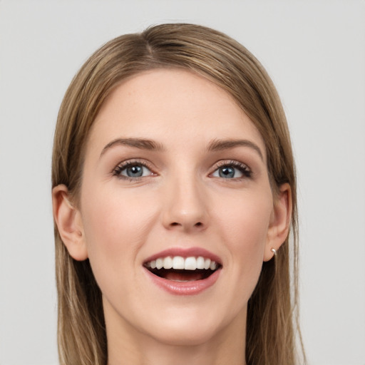 Joyful white young-adult female with long  brown hair and grey eyes