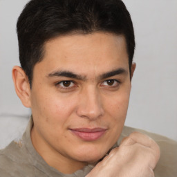 Joyful latino young-adult male with short  brown hair and brown eyes