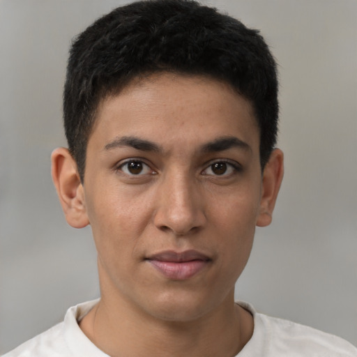 Joyful latino young-adult male with short  brown hair and brown eyes