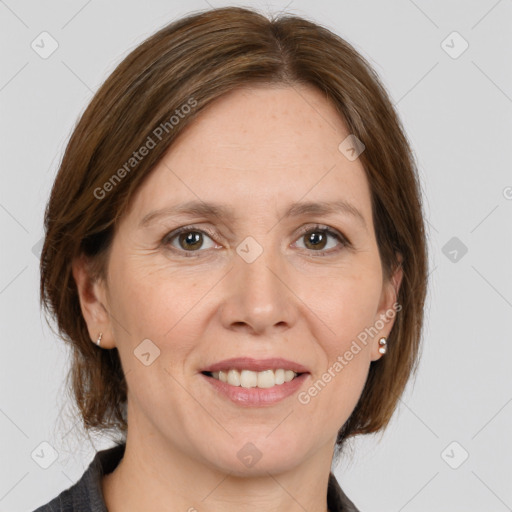 Joyful white adult female with medium  brown hair and grey eyes