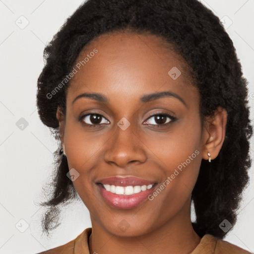 Joyful black young-adult female with long  black hair and brown eyes