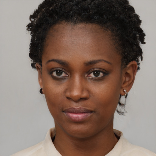 Joyful black young-adult female with short  brown hair and brown eyes